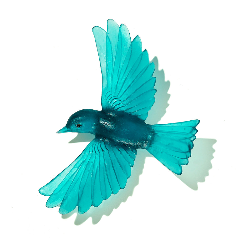 A translucent turquoise blue bird sculpture or wall decor piece shown against a plain white background with a soft shadow.