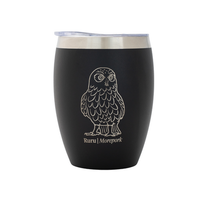 Black coffee cup with an owl design and 'Ruru Morepork' branding on a white background