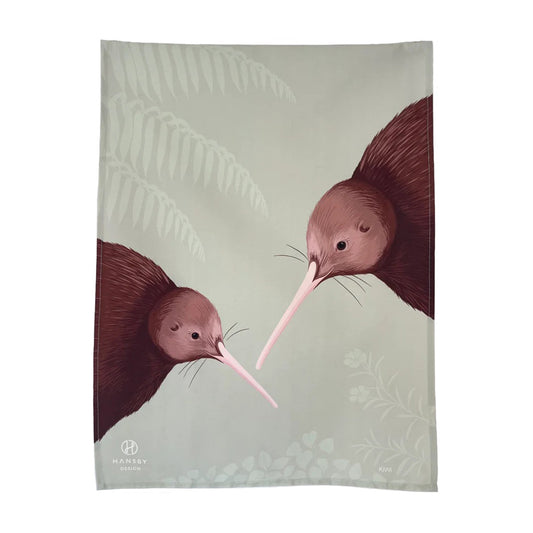 A tea towel featuring two kiwi, designed by artist Cathy Hansby