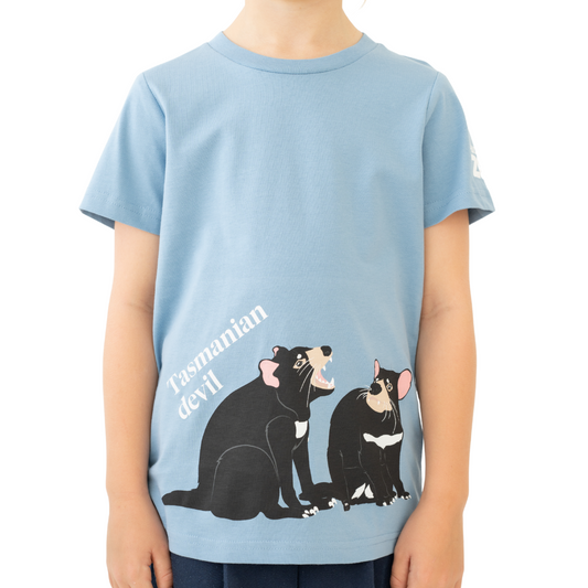 Child wearing a blue t-shirt with Tasmanian Devil illustrations and text.