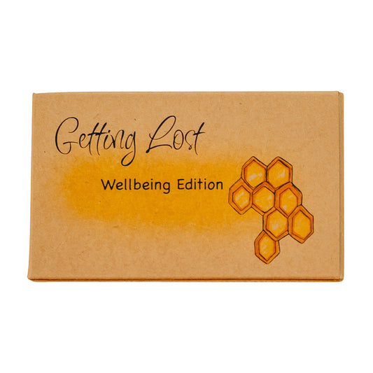 A boxed card game titled 'Getting Lost Wellbeing Edition', with a honeycomb pattern on the front.