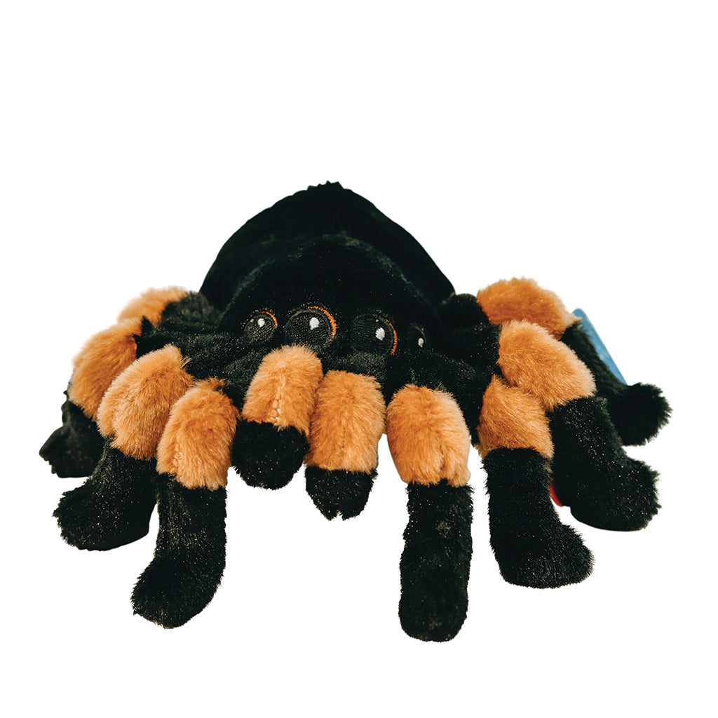 A plush toy resembling a tarantula with black and orange fur, eight eyes, and long legs.