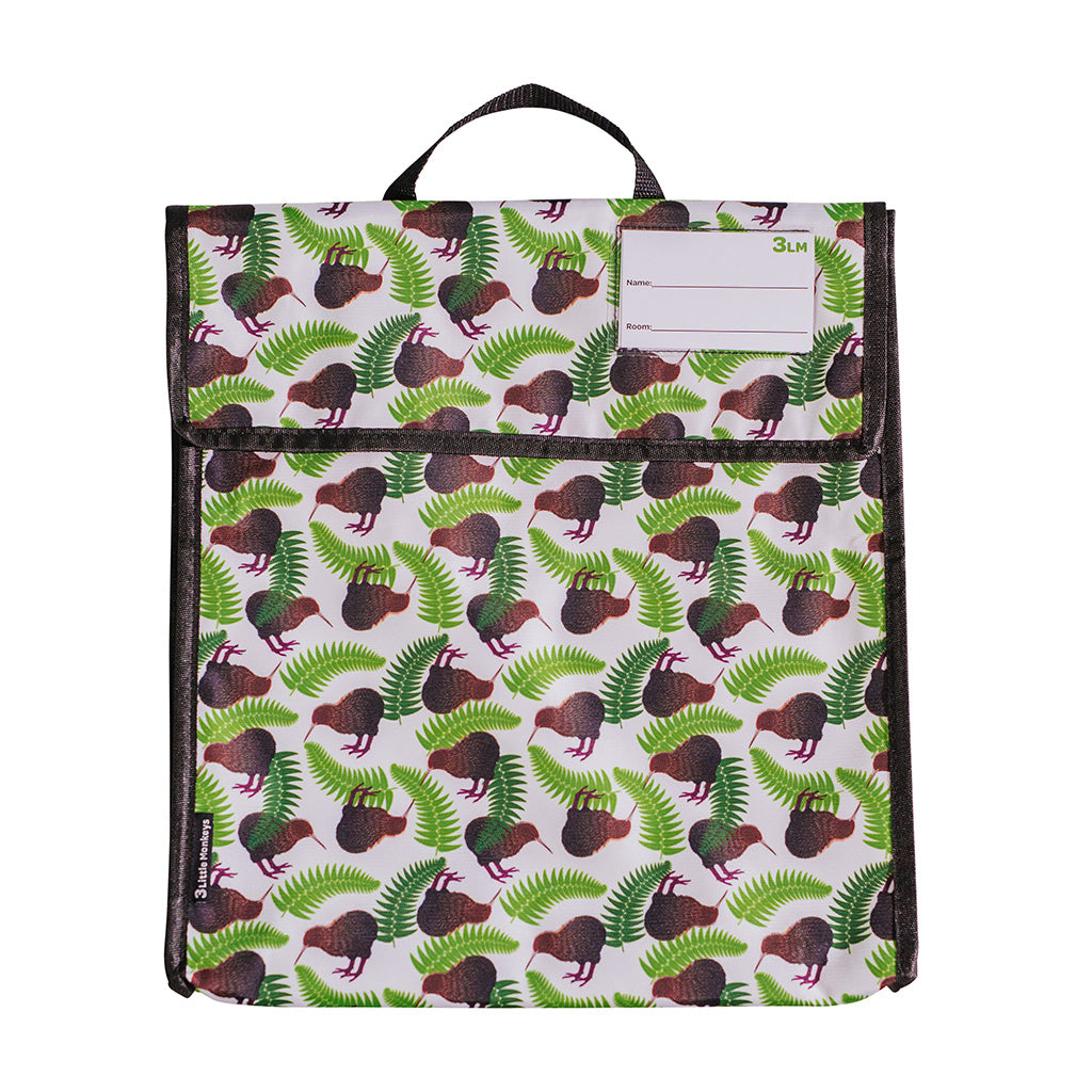 A kids' book bag with a multicolored pattern featuring kiwi birds and ferns, with a carry handle and a name card holder.