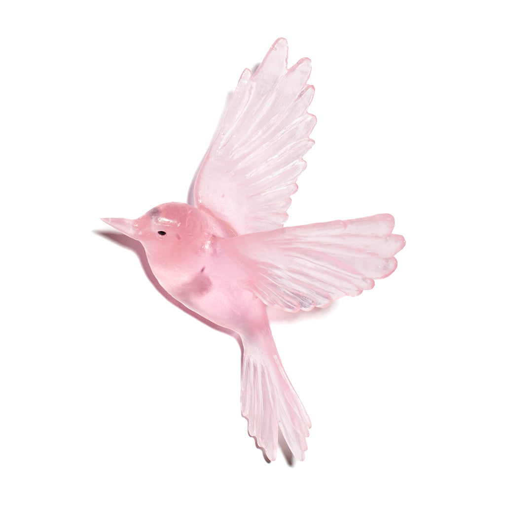 A translucent pink glass bird figurine with wings spread, shown against a plain white background.