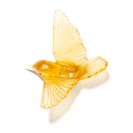 A translucent yellow glass bird figurine with wings spread, shown on a clean white background with a soft shadow.