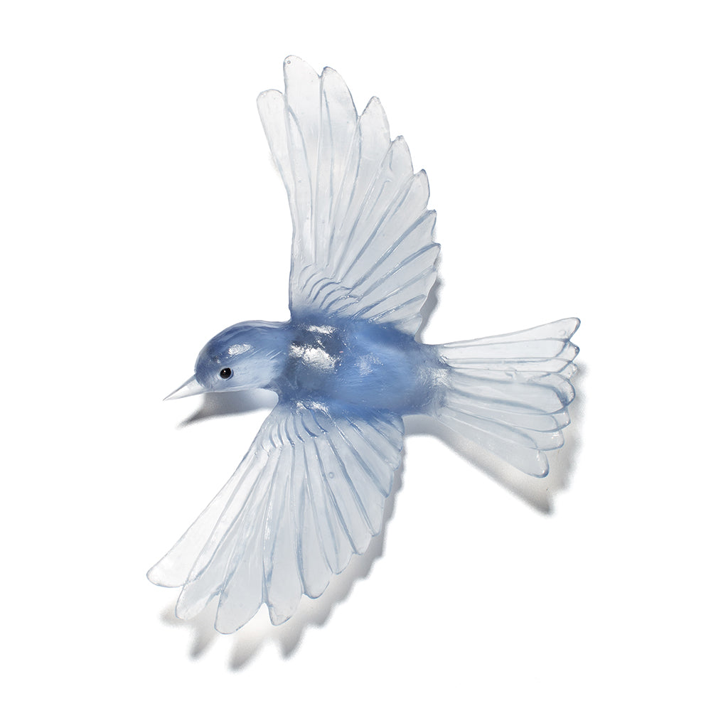 A translucent blue glass bird sculpture with wings spread, shown against a plain white background.