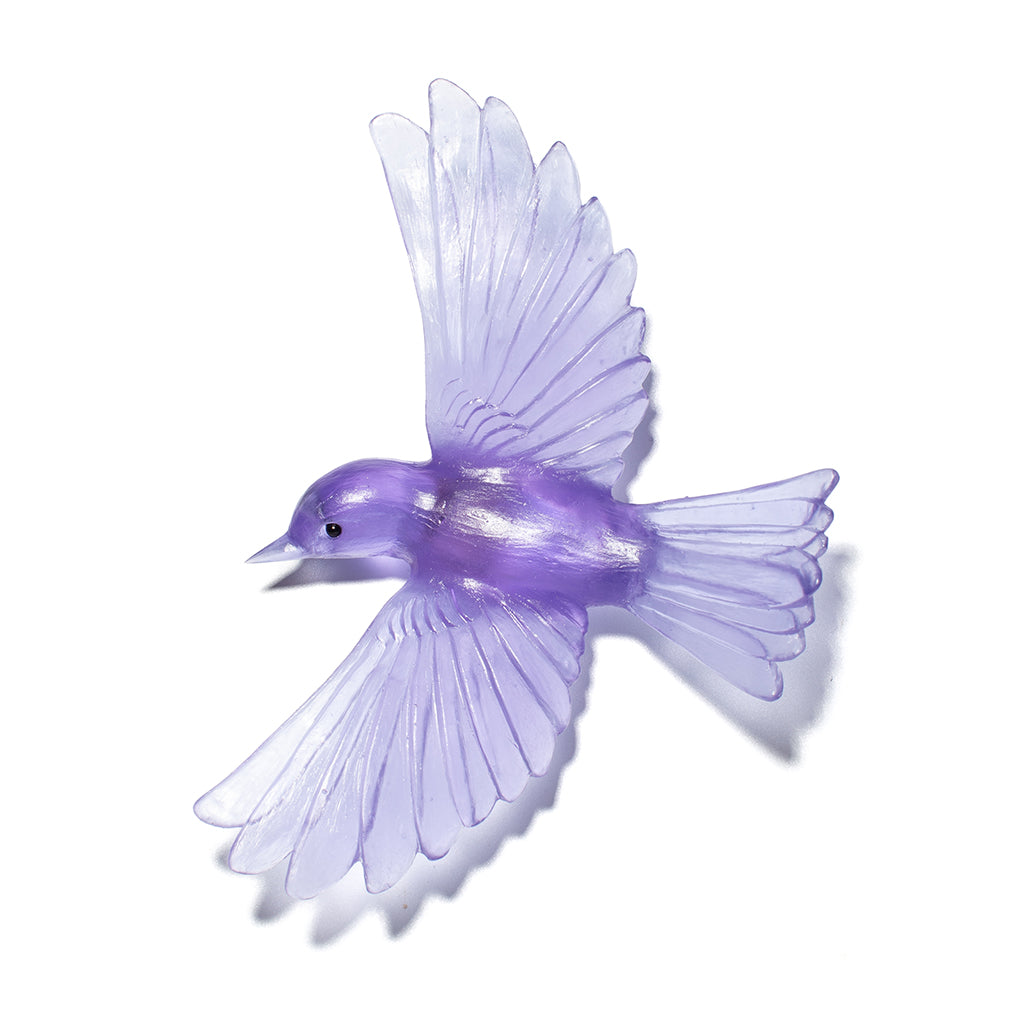 A translucent purple bird ornament with outstretched wings, shown on a plain white background.