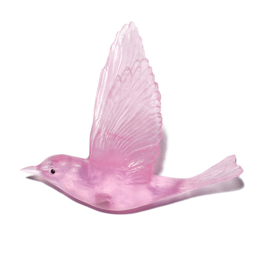 A translucent pink bird figurine with wings raised, shown on a plain white background.