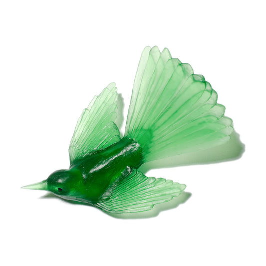 A translucent green bird figurine with spread wings, shown on a clean white background.