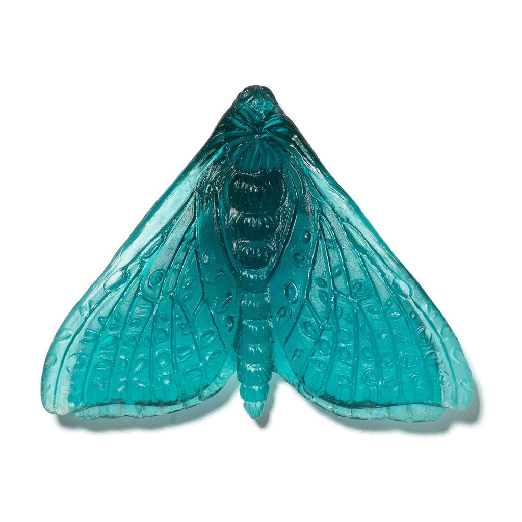 A translucent turquoise blue glass moth ornament with detailed wing patterns, shown against a plain white background.