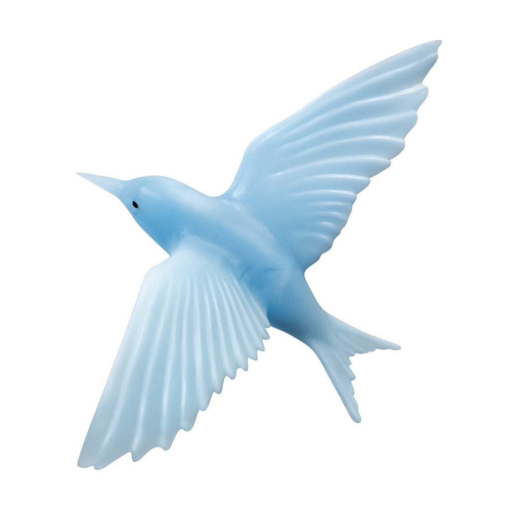 A light blue flying bird figurine with outstretched wings, shown against a plain white background.