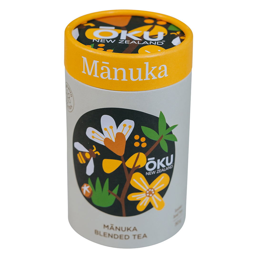 A cylindrical container of Mānuka blended tea with illustrations of manuka flowers and leaves on the label.