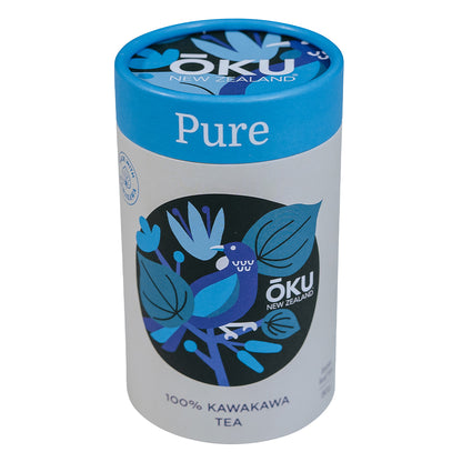 A cylindrical tin can of Oku Tea Pure, featuring a blue lid and a label with a blue and green color scheme, indicating 100% Kawakawa tea.