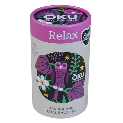 A cylindrical container of Tea Relax blend featuring illustrations of an owl, flowers, and leaves with a pink lid, set against a white background.