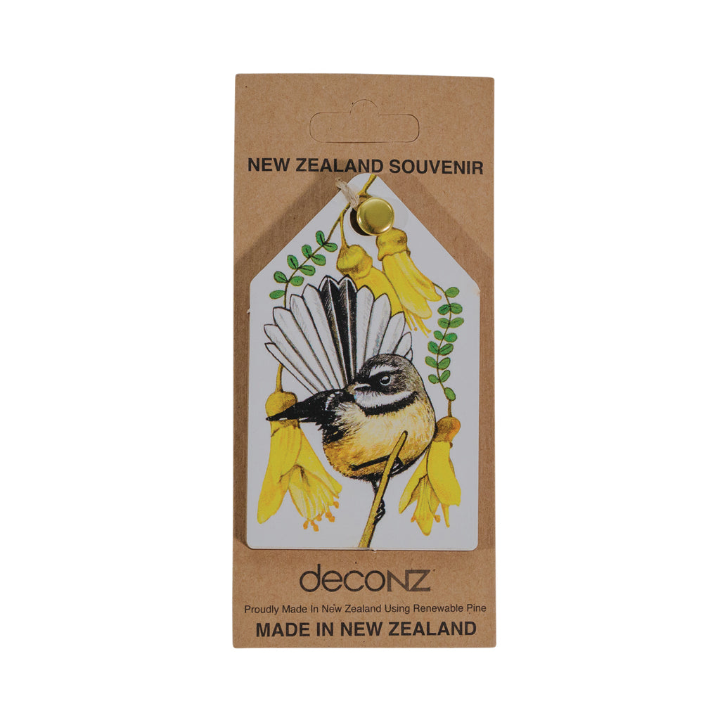 A Christmas decoration featuring a fantail bird and kowhai flower design, with the text 'Made in New Zealand' at the bottom.