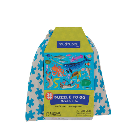 A 36-piece Ocean Life themed puzzle by Mudpuppy, packaged in a blue and green drawstring reusable bag with the brand's logo and a colorful underwater animal illustration.