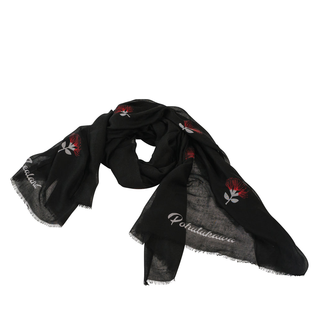 A black scarf with red and white Pohutukawa flowers on it.