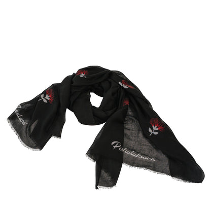 A black scarf with red and white Pohutukawa flowers on it.